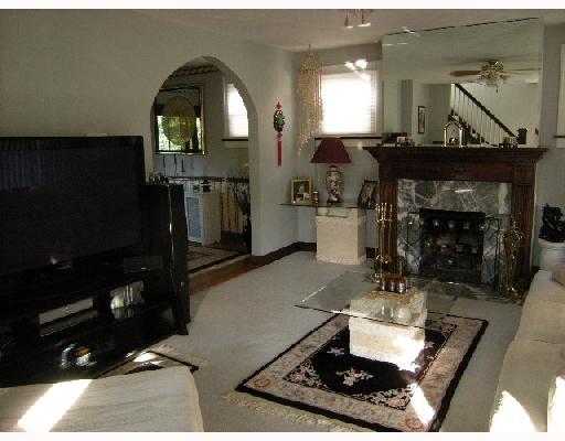 Living Room. The spacious living room has a beautiful fireplace with a wood mantle