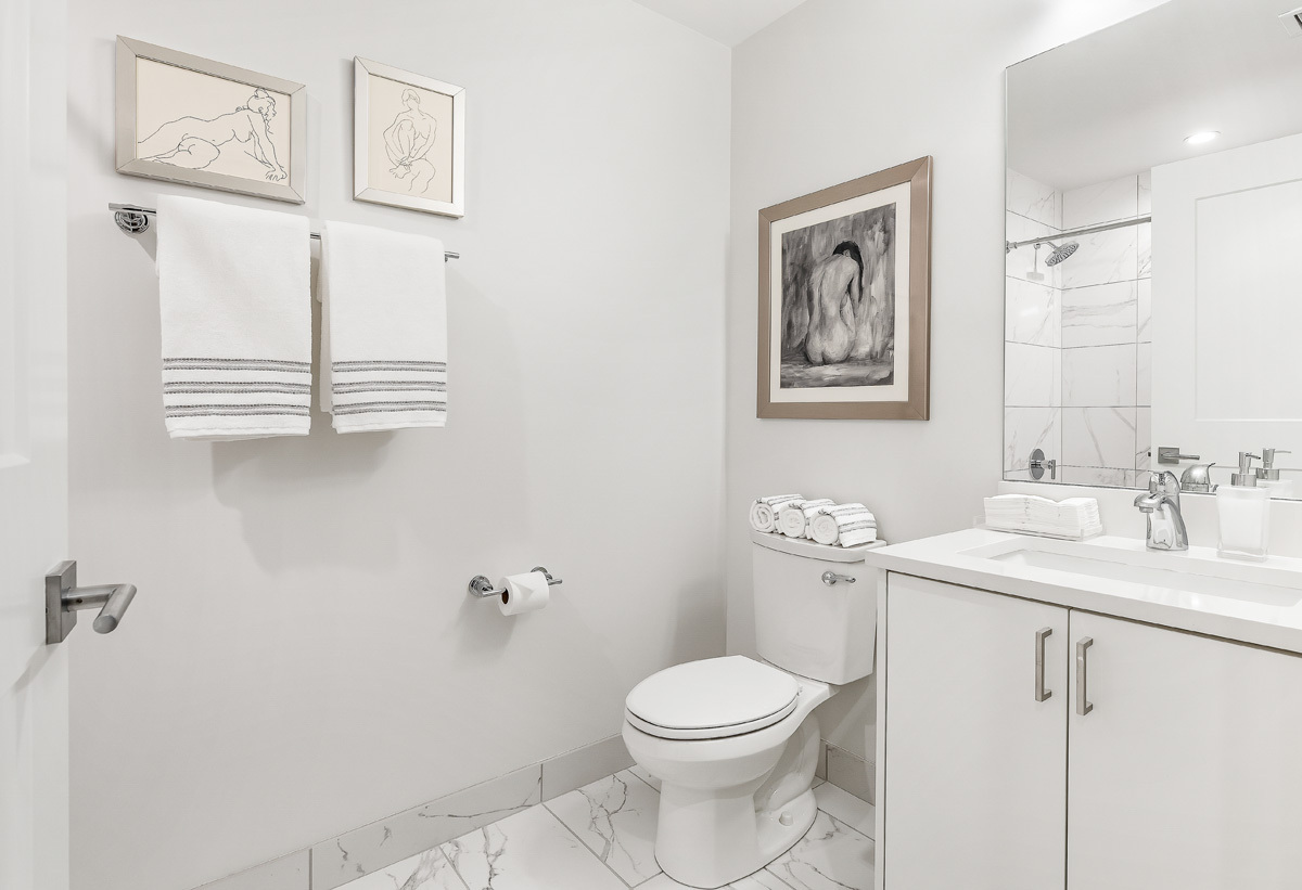 435 Madison Street, Unit 207 Oak Park, IL 60302 - Photo 19 of 21 a bathroom with a toilet a sink and mirror