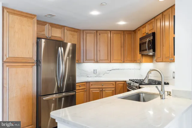 a kitchen with refrigerator cabinets and a sink