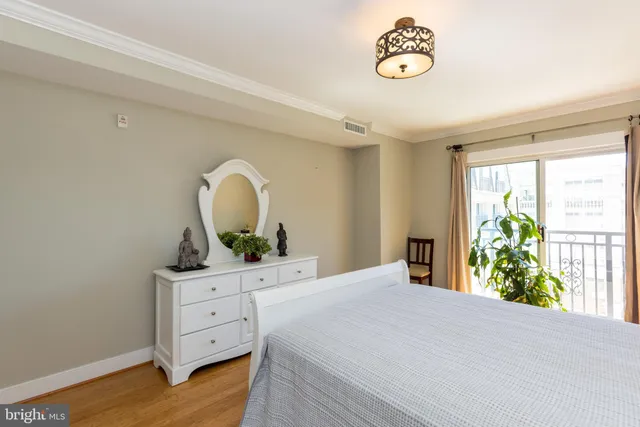 a bedroom with a bed and a dresser in it