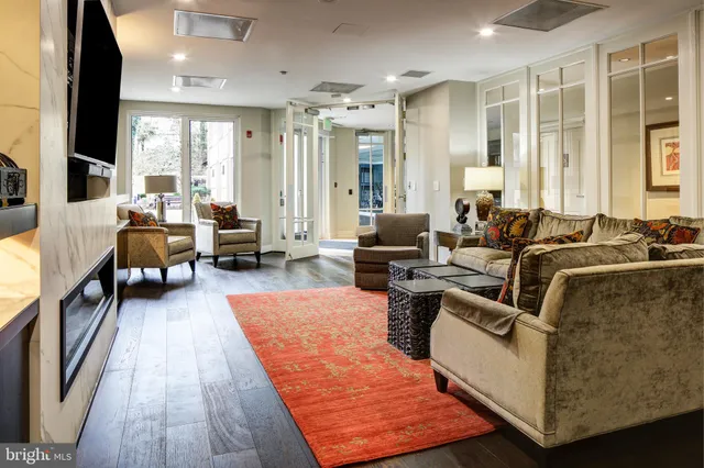 a view of a swimming pool with a table and chairs under an umbrella