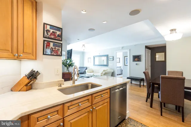 a kitchen with a sink cabinets and wooden floor