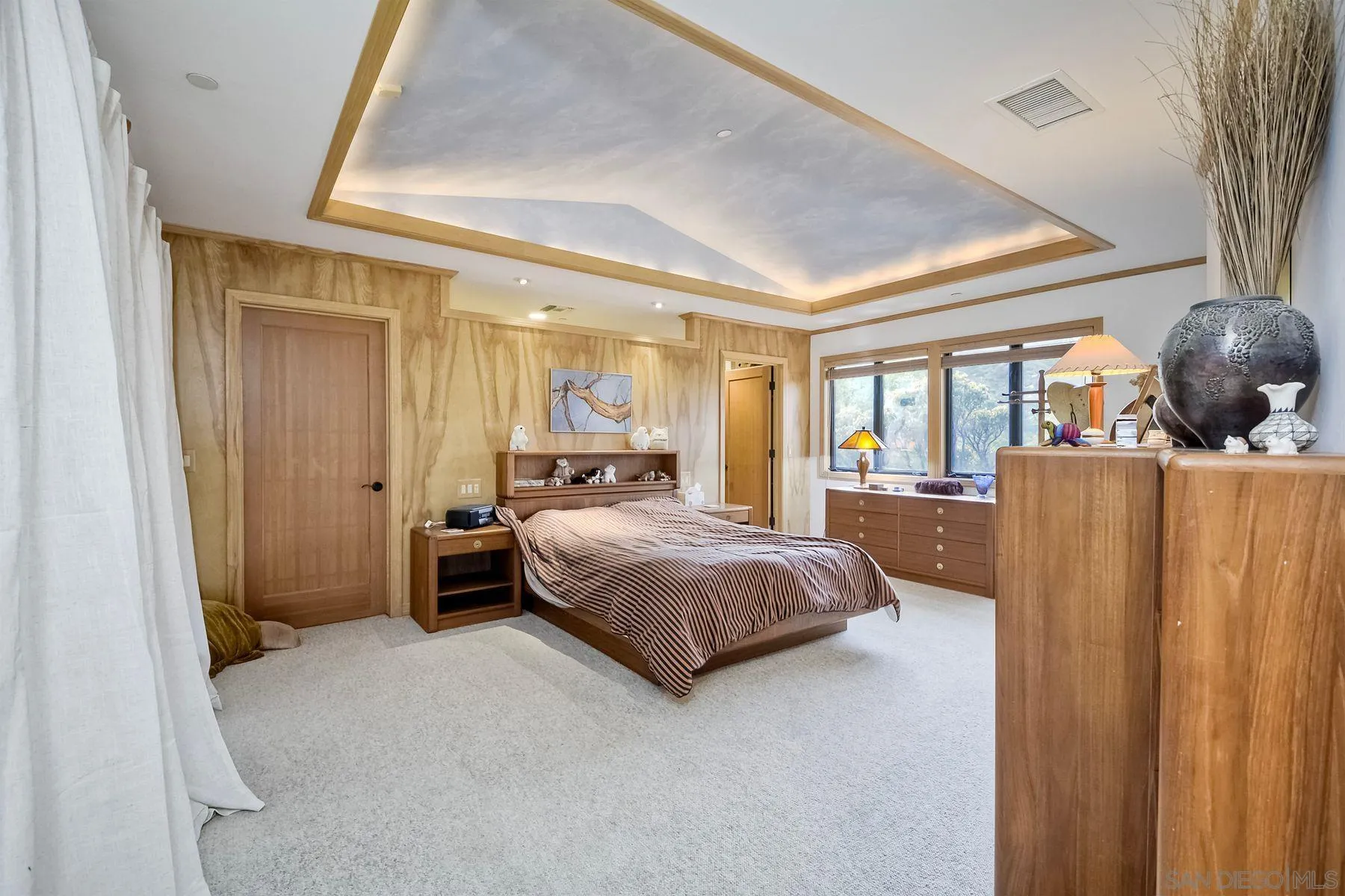 14825 Midland Road Poway, CA 92064 - Photo 27 of 33 a bedroom with a large bed and large windows