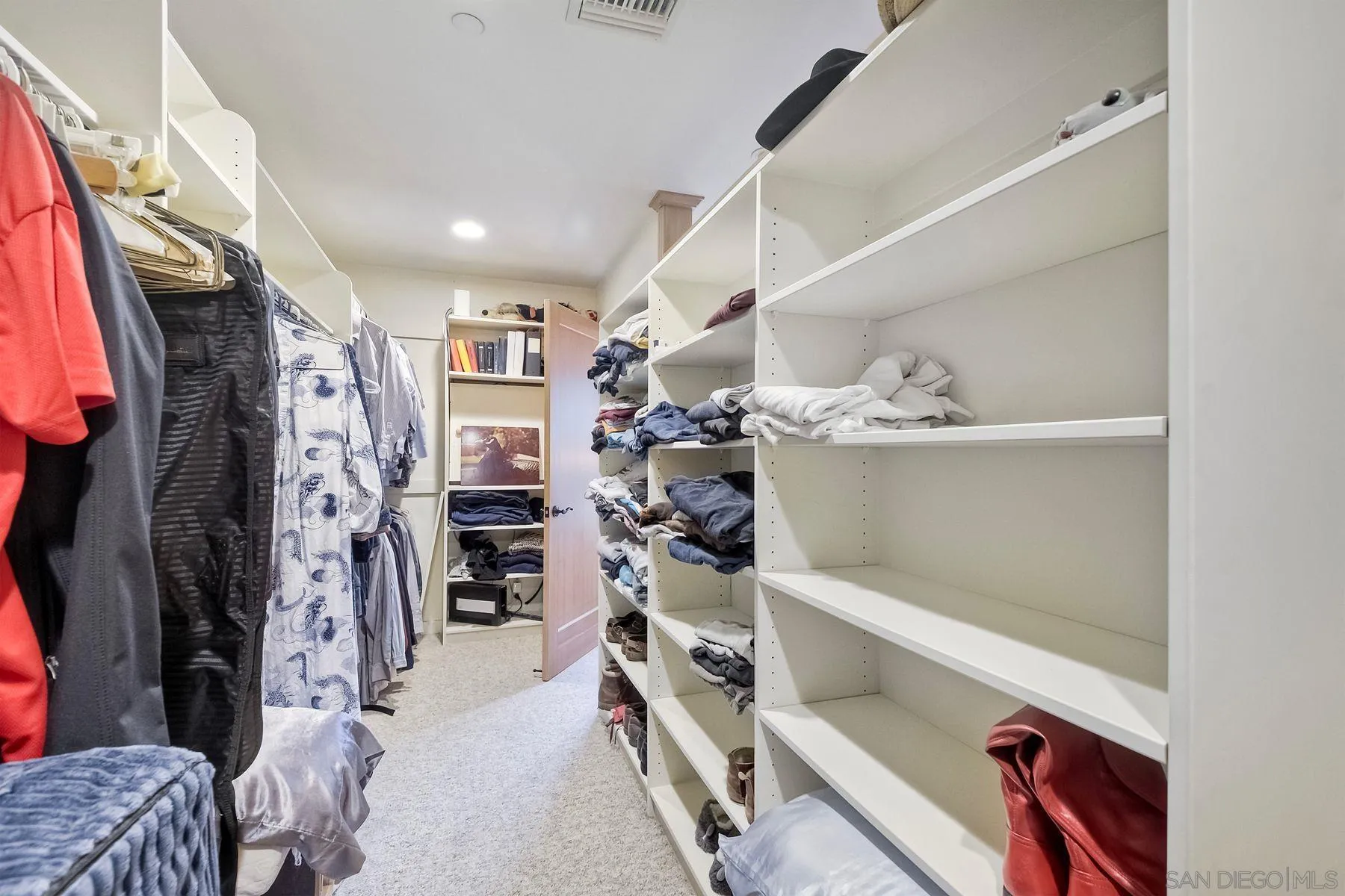 14825 Midland Road Poway, CA 92064 - Photo 28 of 33 a view of walk in closet with clothes and shoes