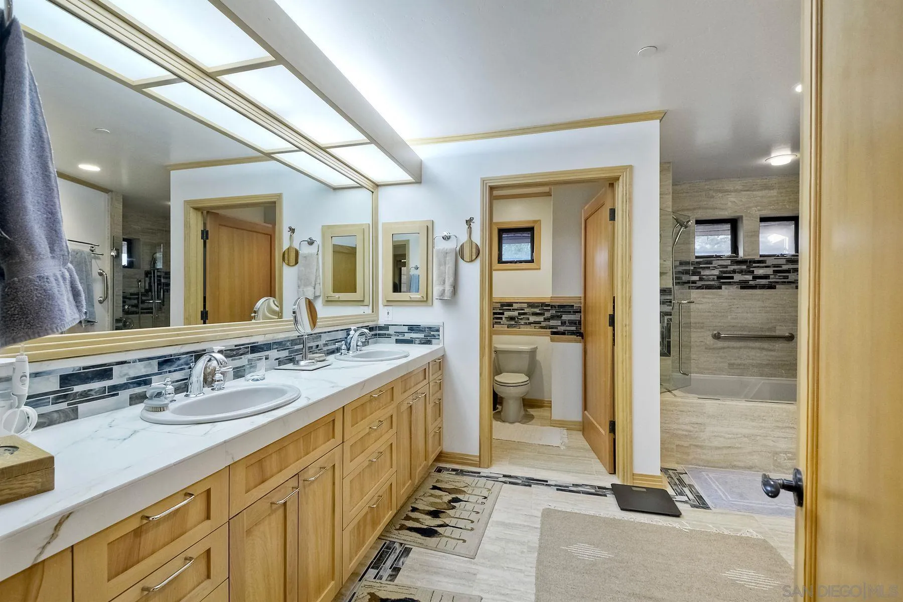 14825 Midland Road Poway, CA 92064 - Photo 29 of 33 a spacious bathroom with a shower sink and mirror