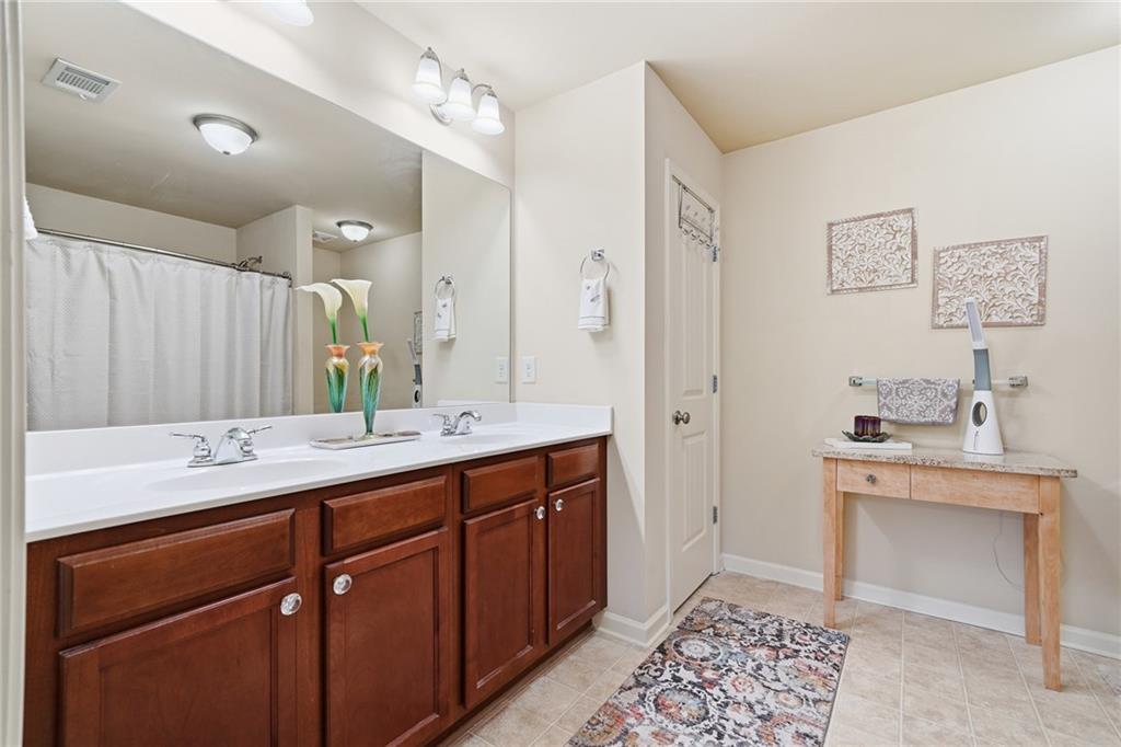 608 Myers Gate Road Ball Ground, GA 30107 - Photo 20 of 31 a spacious bathroom with a sink and a mirror