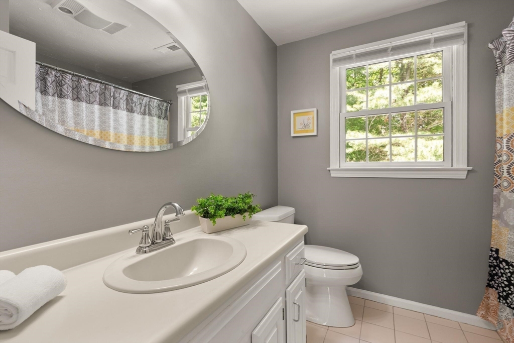 67 Bridle Path Franklin, MA 02038 - Photo 23 of 35 a bathroom with a toilet a sink and mirror