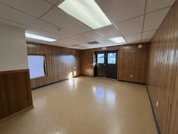 a view of a livingroom with an empty space and a window