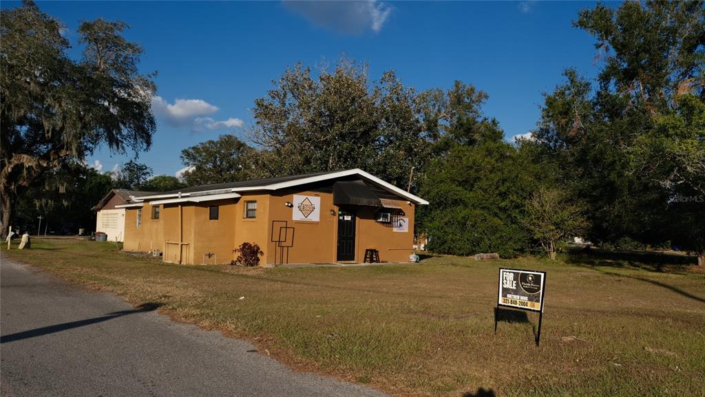 34 4th Street Southwest Fort Meade, FL 33841 - Photo 11 of 31 a view of a blue house with a yard