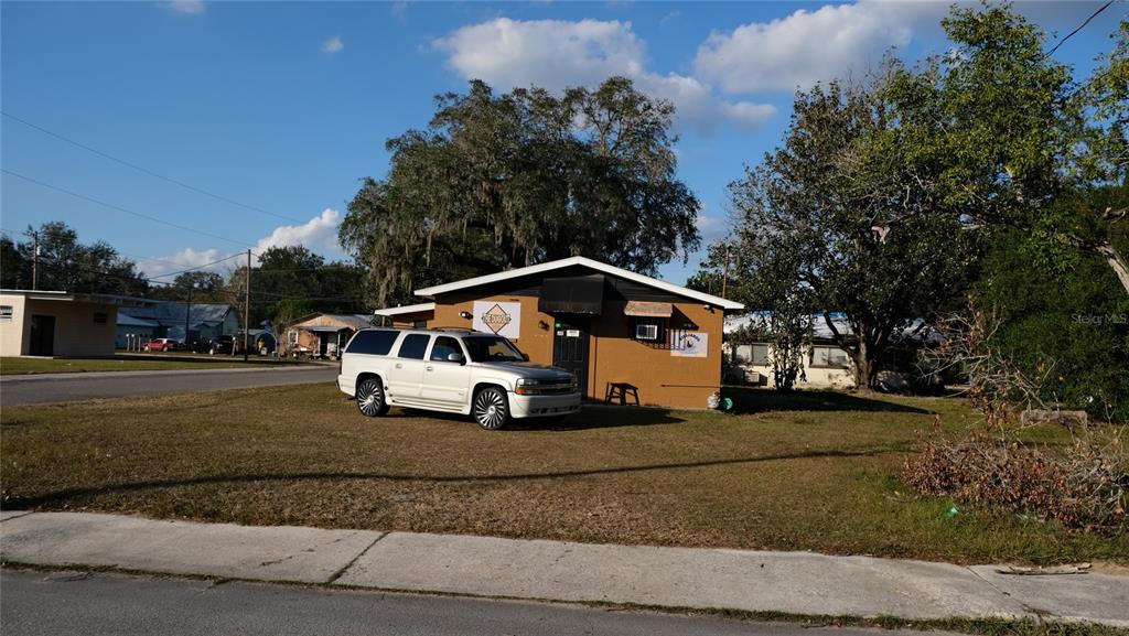 34 4th Street Southwest Fort Meade, FL 33841 - Photo 4 of 31 a white house with tall trees in the background