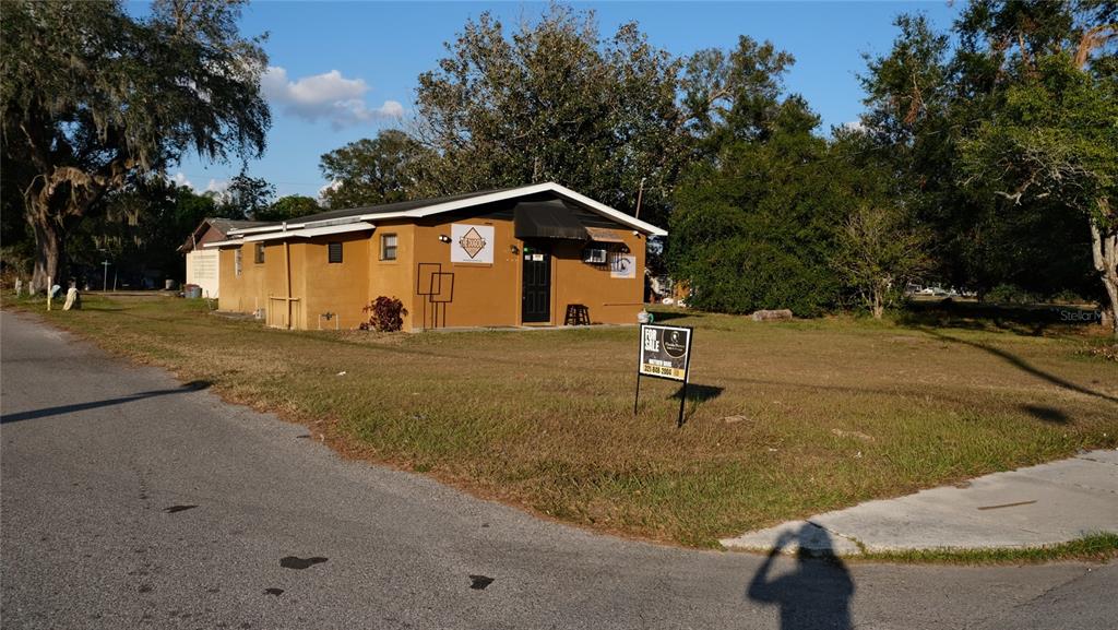 34 4th Street Southwest Fort Meade, FL 33841 - Photo 9 of 31 a blue house with trees in front of it