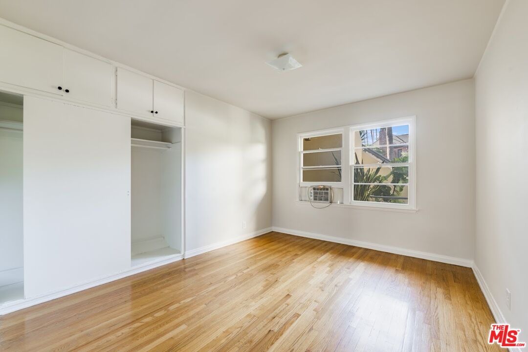 1706 North Stanley Avenue, Unit 2 Los Angeles, CA 90046 - Photo 3 of 10 wooden floor in an empty room with a window
