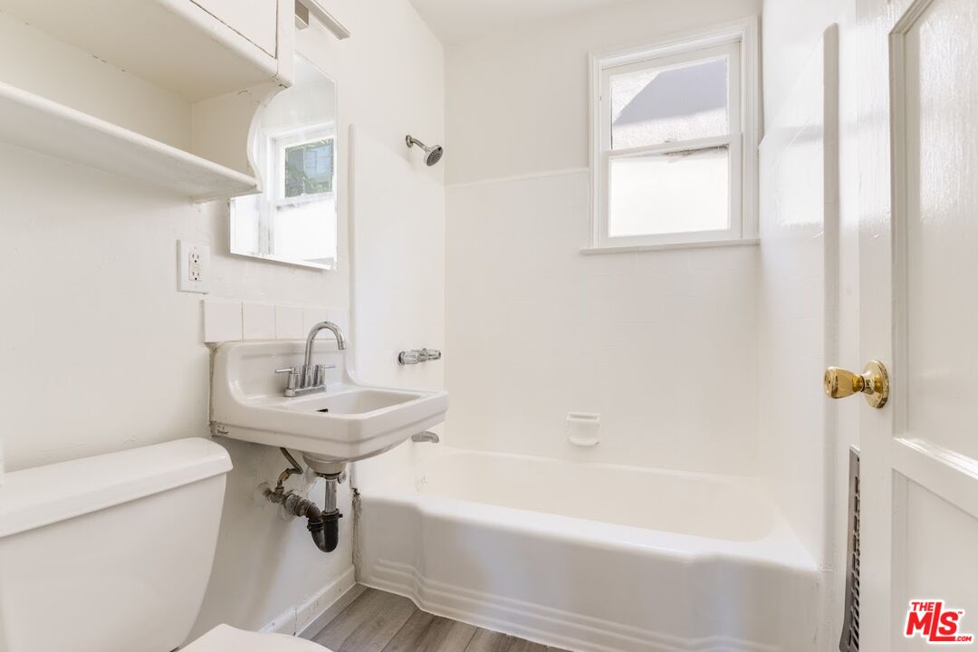 1706 North Stanley Avenue, Unit 2 Los Angeles, CA 90046 - Photo 7 of 10 a bathroom with a sink a toilet and a bathtub