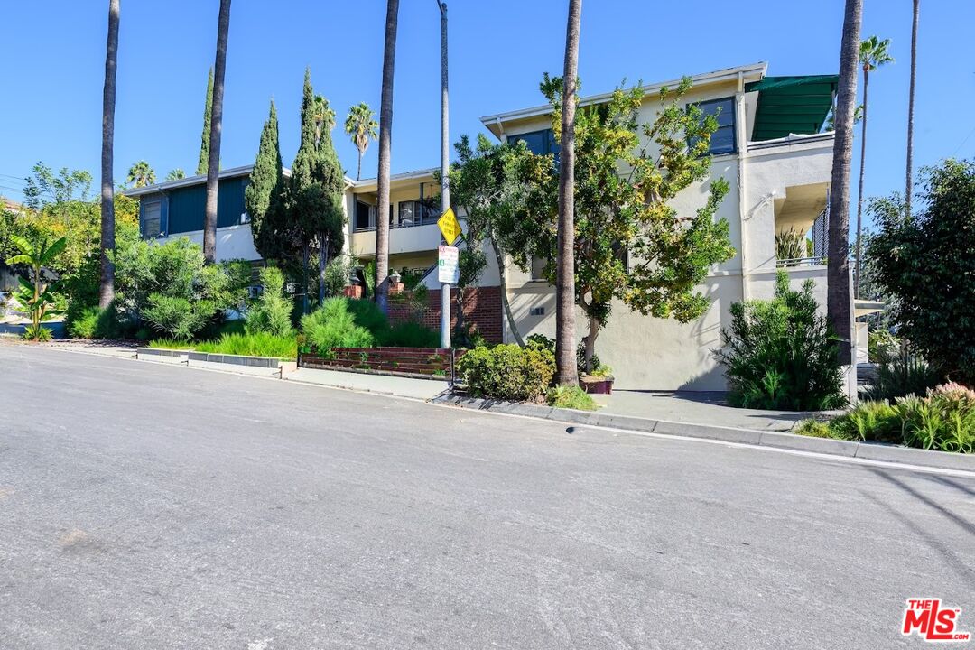 1706 North Stanley Avenue, Unit 2 Los Angeles, CA 90046 - Photo 9 of 10 a front view of a house with a yard and potted plants