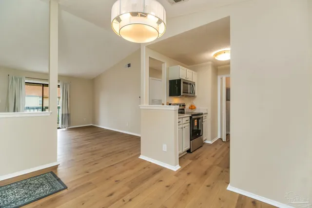 a kitchen with a refrigerator and a stove top oven