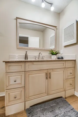 a bathroom with a sink a vanity and a mirror