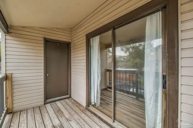 a view of a balcony with wooden floor