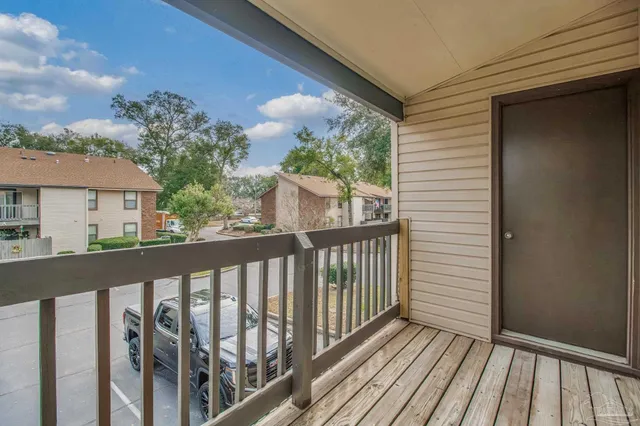 a view of a balcony with wooden floor