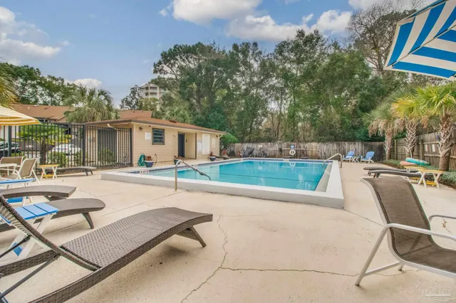 a view of a house with swimming pool and sitting area