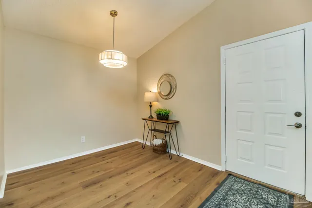 a view of a room with wooden floor and white walls