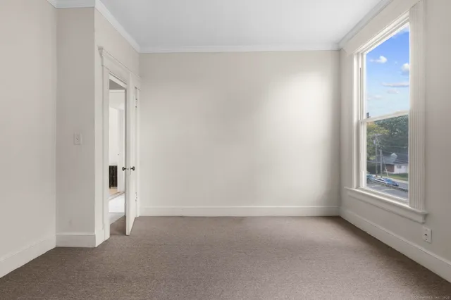 an empty room with windows and closet