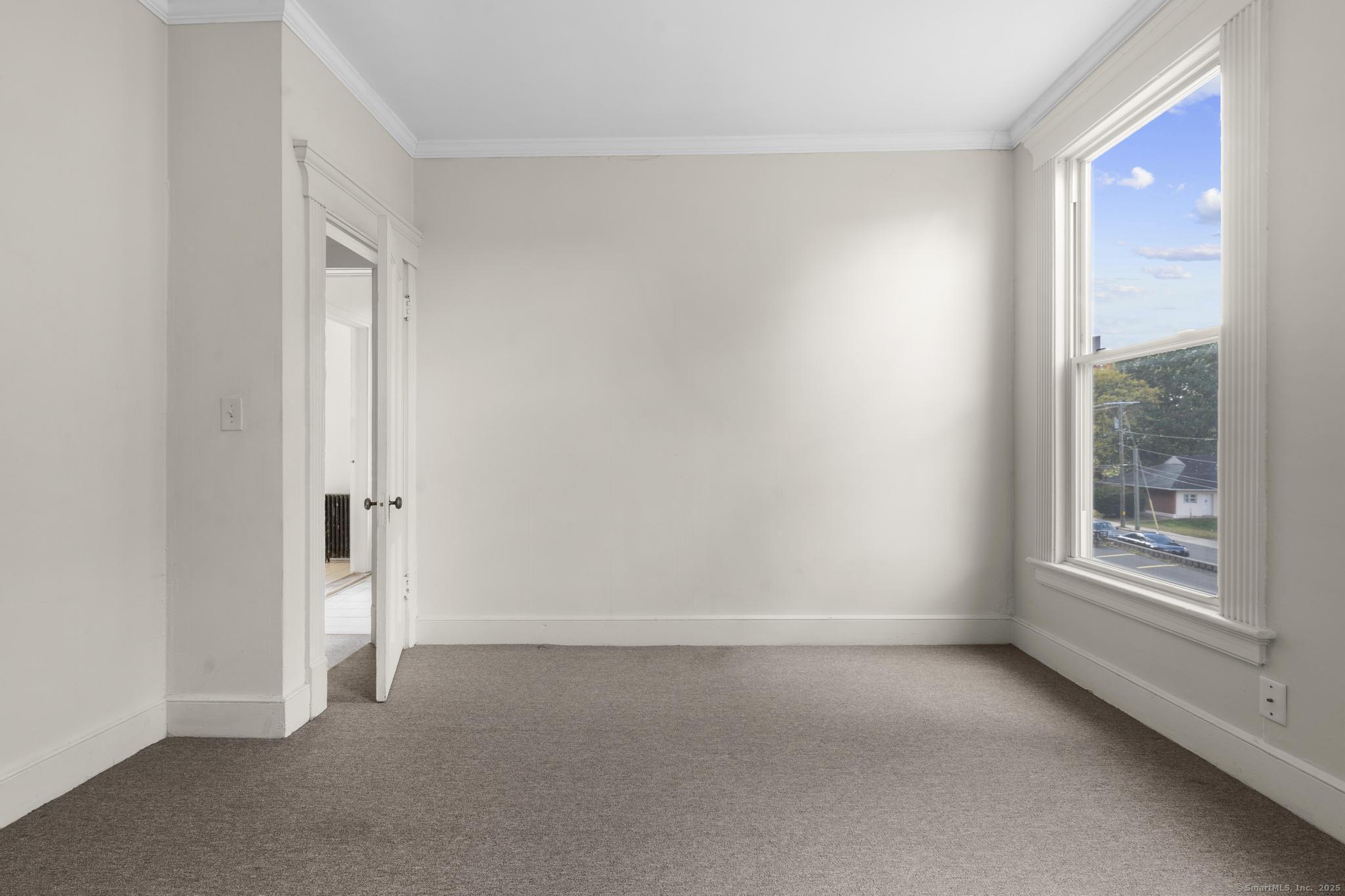 113 East Main Street, Unit 5 Meriden, CT 06450 - Photo 12 of 21 an empty room with windows and closet