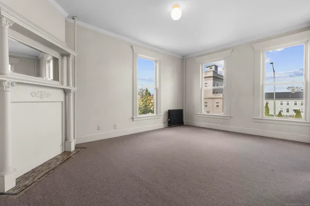 an empty room with windows and entrance