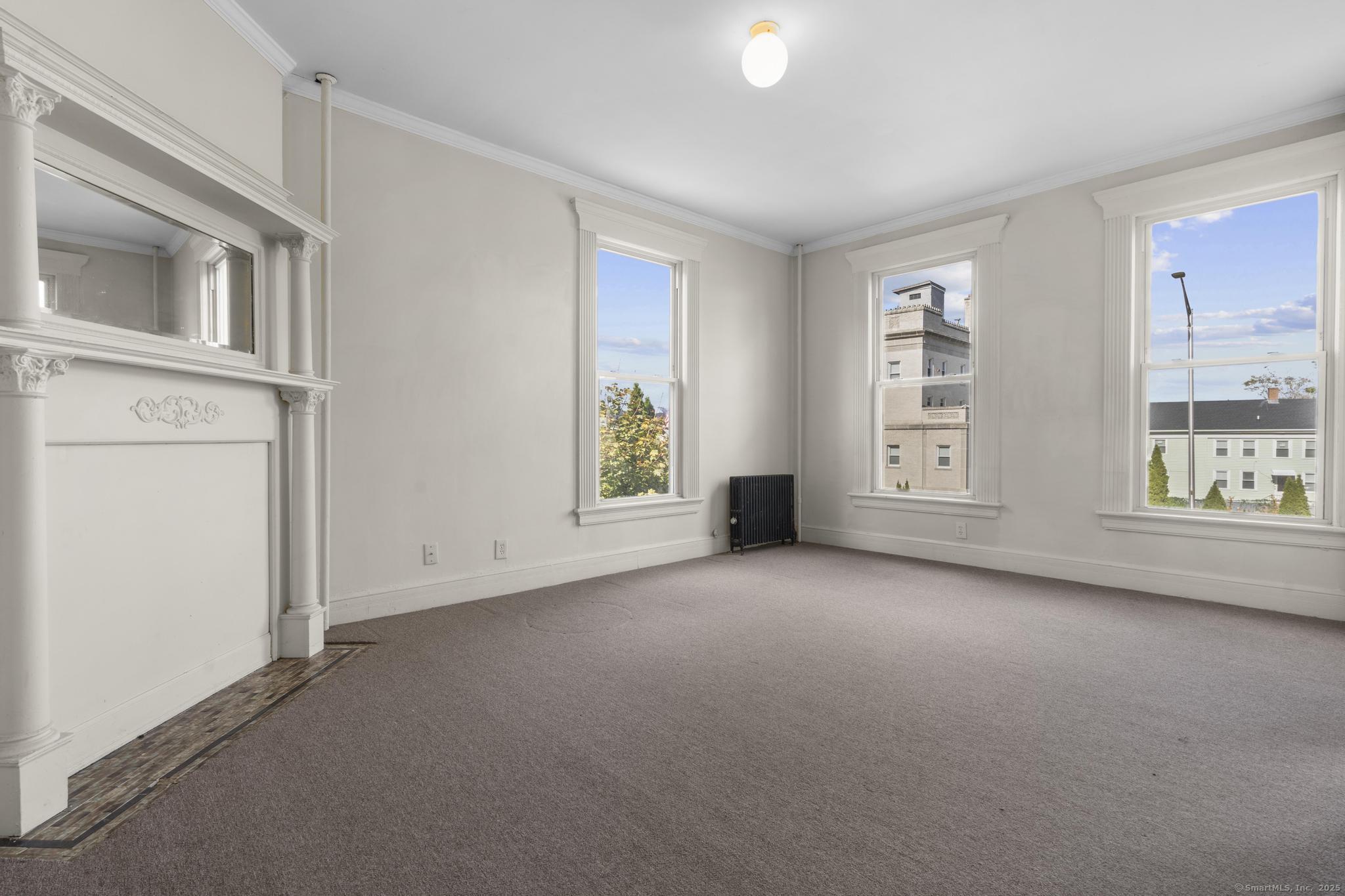 113 East Main Street, Unit 5 Meriden, CT 06450 - Photo 13 of 21 an empty room with windows and entrance