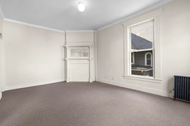 an empty room with a empty space and windows