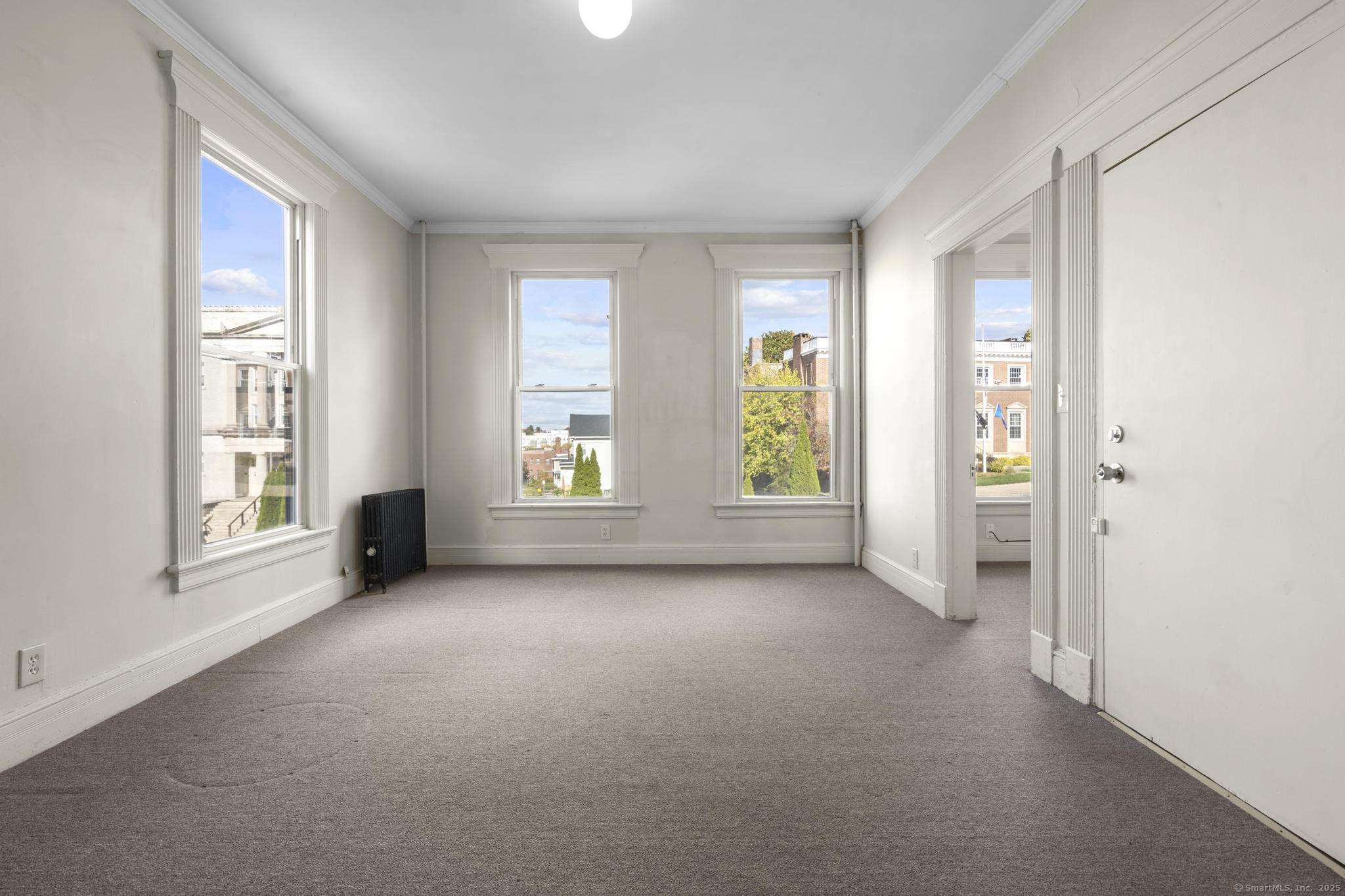 113 East Main Street, Unit 5 Meriden, CT 06450 - Photo 20 of 21 an empty room with windows and closet