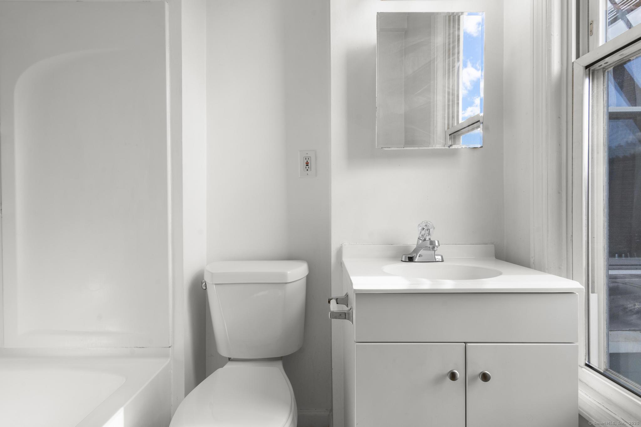 113 East Main Street, Unit 5 Meriden, CT 06450 - Photo 8 of 21 a bathroom with a toilet sink and mirror