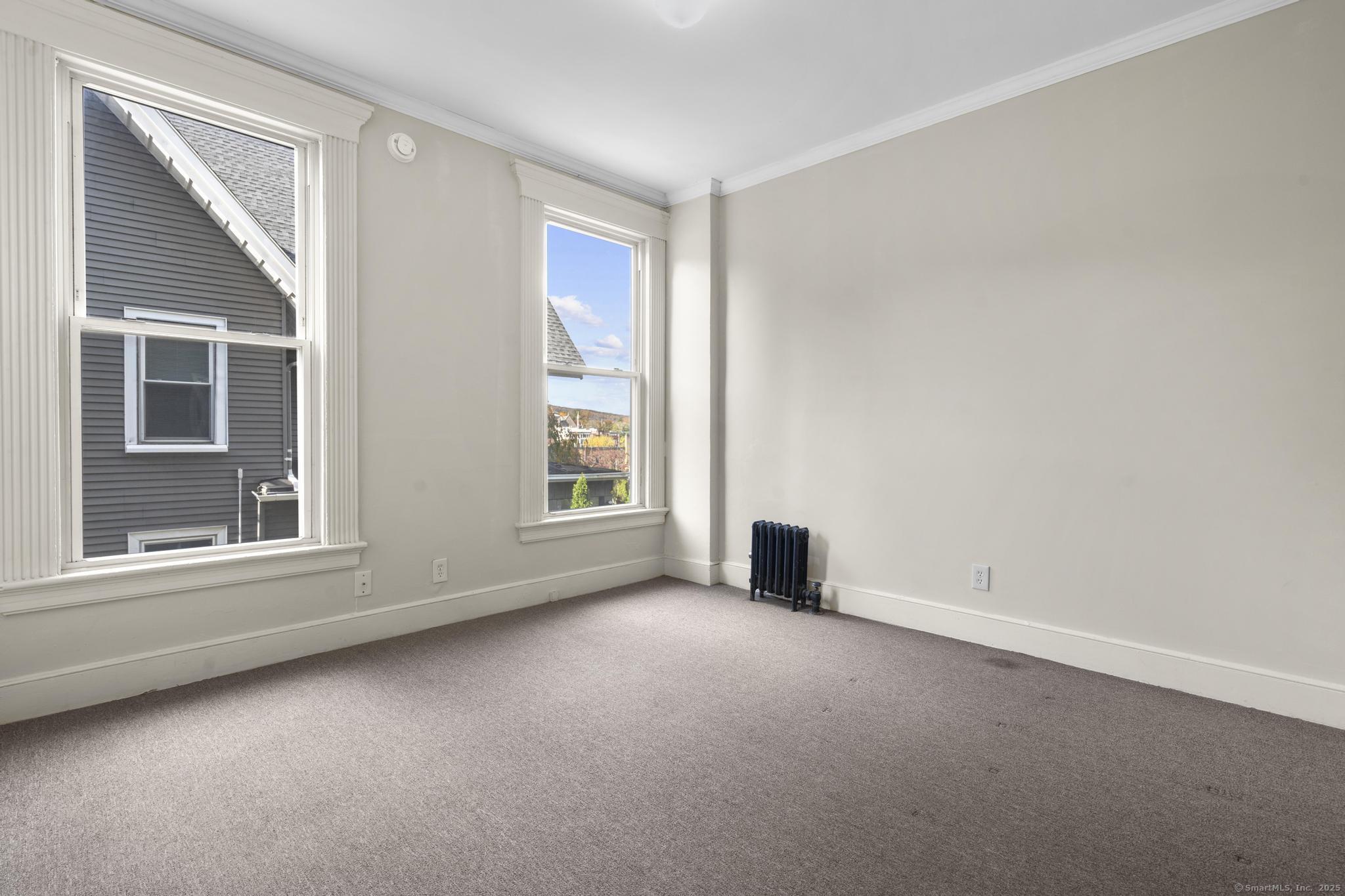 113 East Main Street, Unit 5 Meriden, CT 06450 - Photo 10 of 21 an empty room with a window