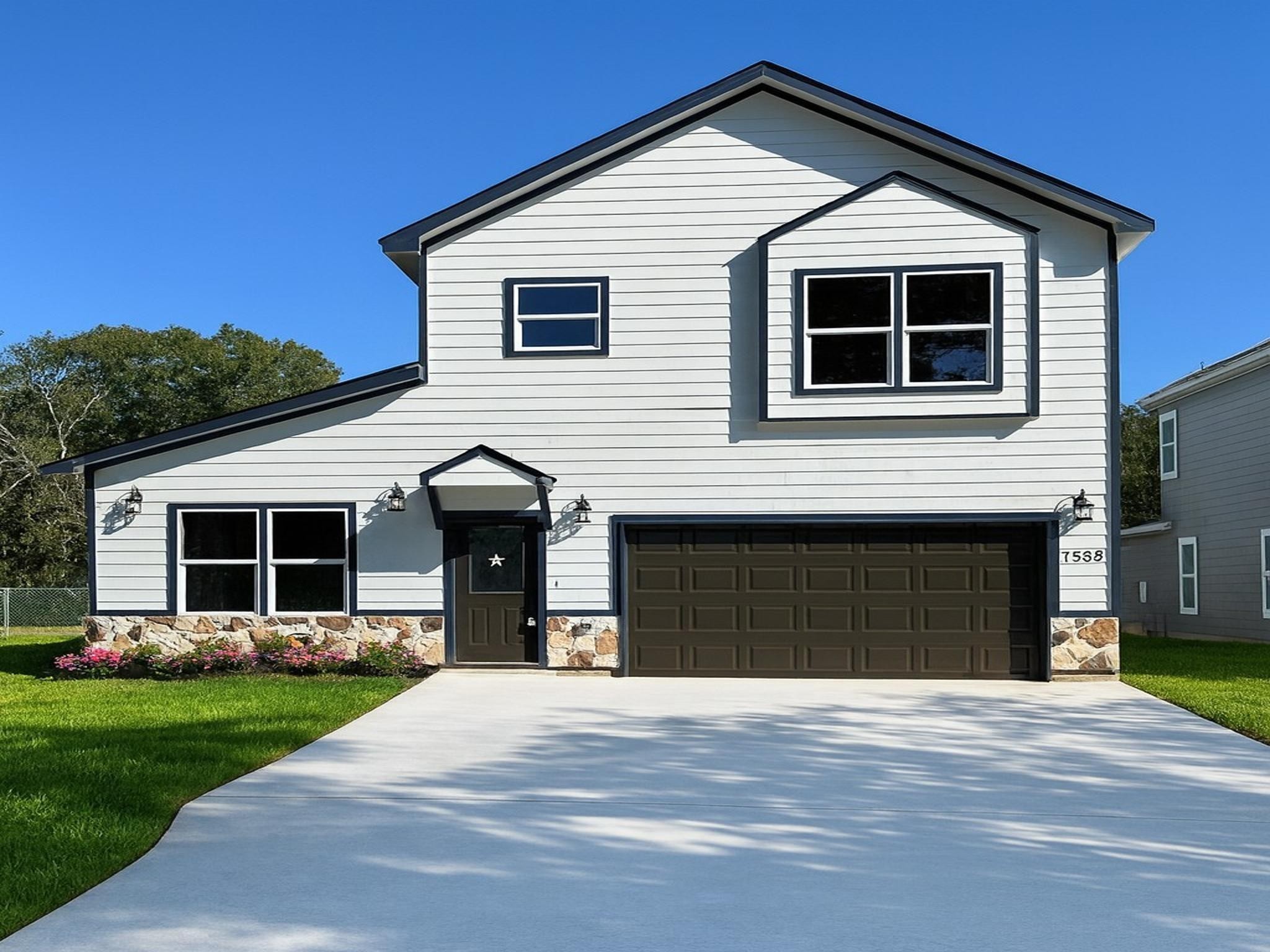 a front view of a house with a yard and garage