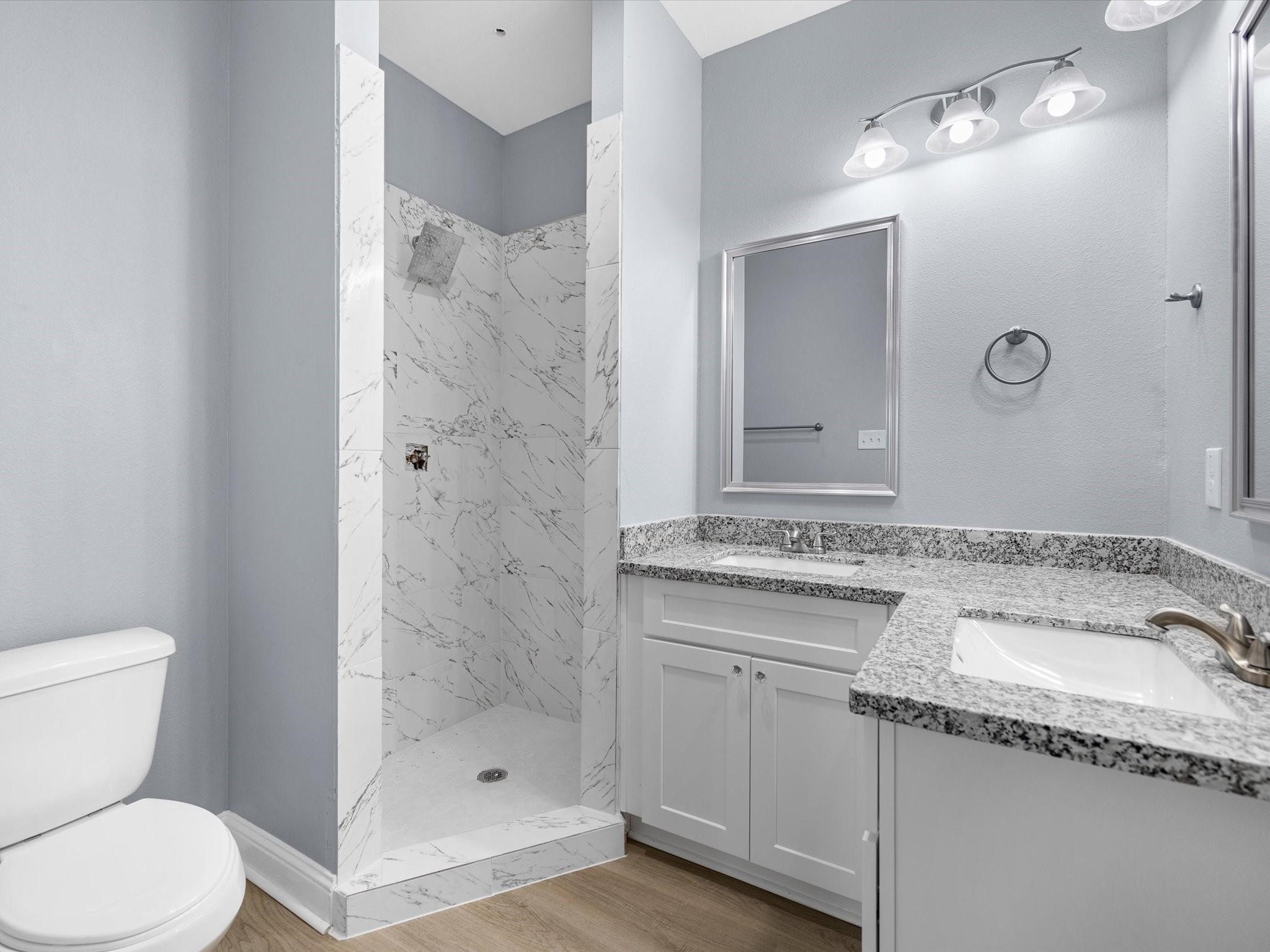 3528 South Street Brookshire, TX 77423 - Photo 11 of 18 a bathroom with a granite countertop sink a toilet and shower