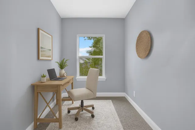 a workspace with furniture and a window