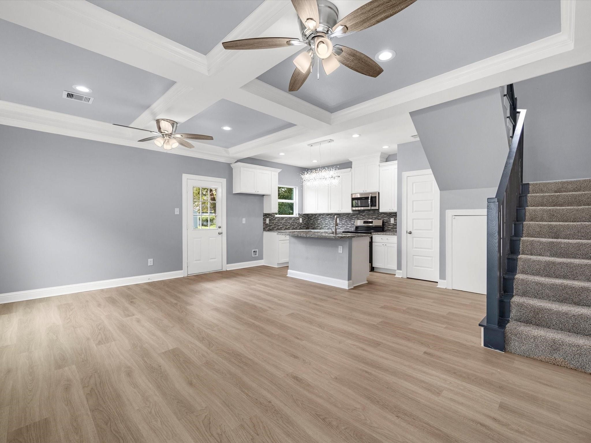 3528 South Street Brookshire, TX 77423 - Photo 2 of 18 a view of an empty room with wooden floor and a ceiling fan