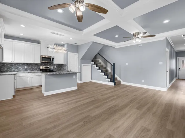 a view of kitchen with sink microwave and cabinets
