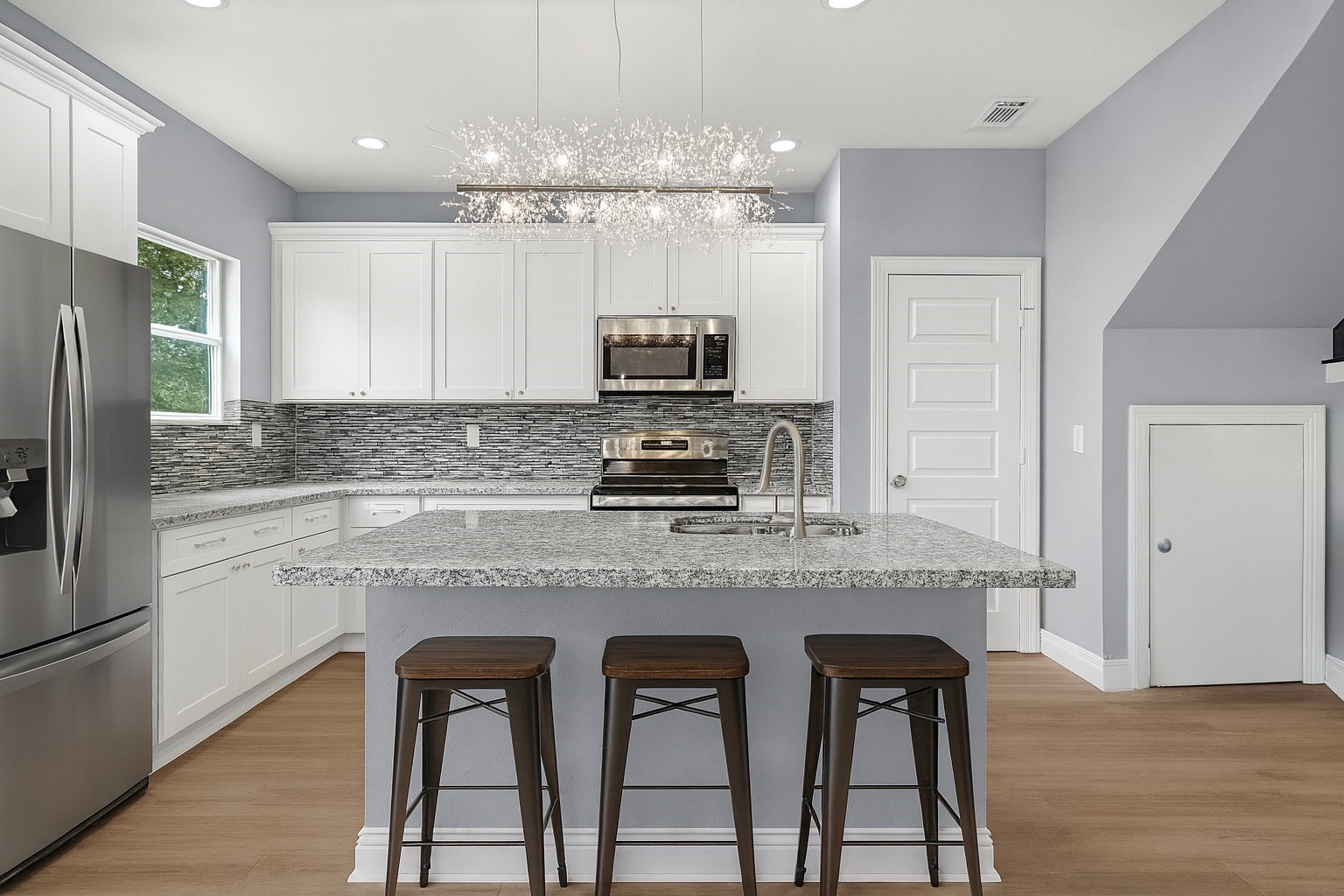 3528 South Street Brookshire, TX 77423 - Photo 5 of 18 a kitchen with cabinets a counter and stainless steel appliances