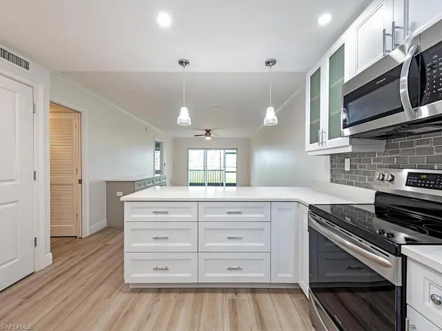 a kitchen with stainless steel appliances a stove microwave and cabinets