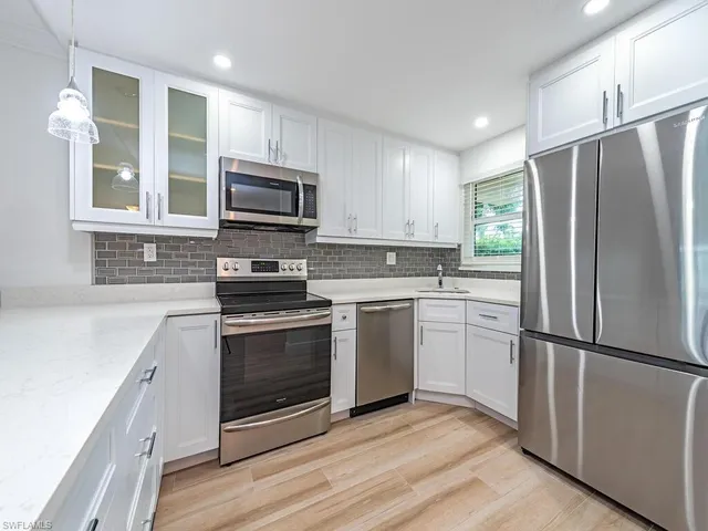 a kitchen with a refrigerator stove and microwave