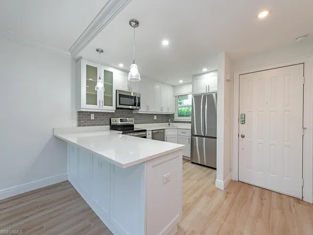 a kitchen with stainless steel appliances a sink stove and refrigerator