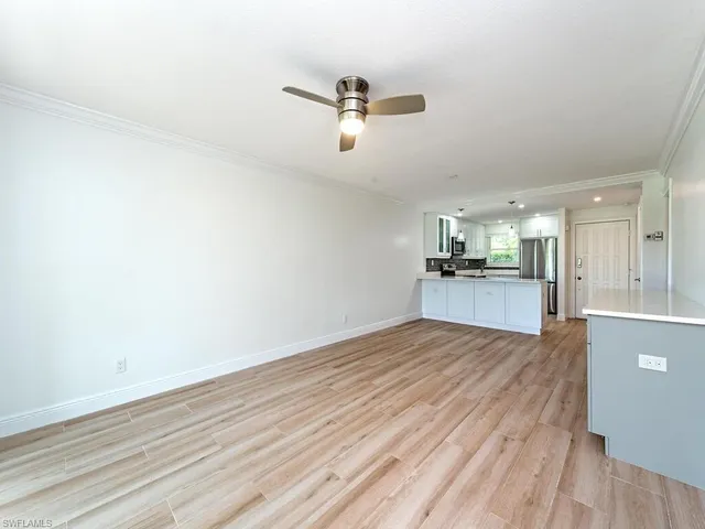 a view of empty room with wooden floor and windows