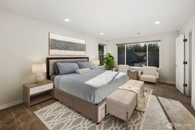 a bedroom with a large bed and a couch