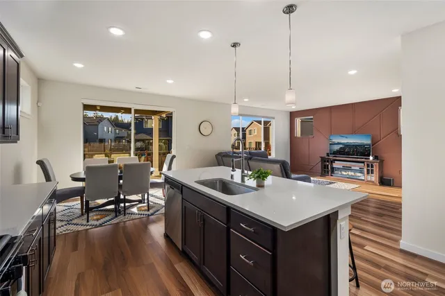 a kitchen with a stove and chairs