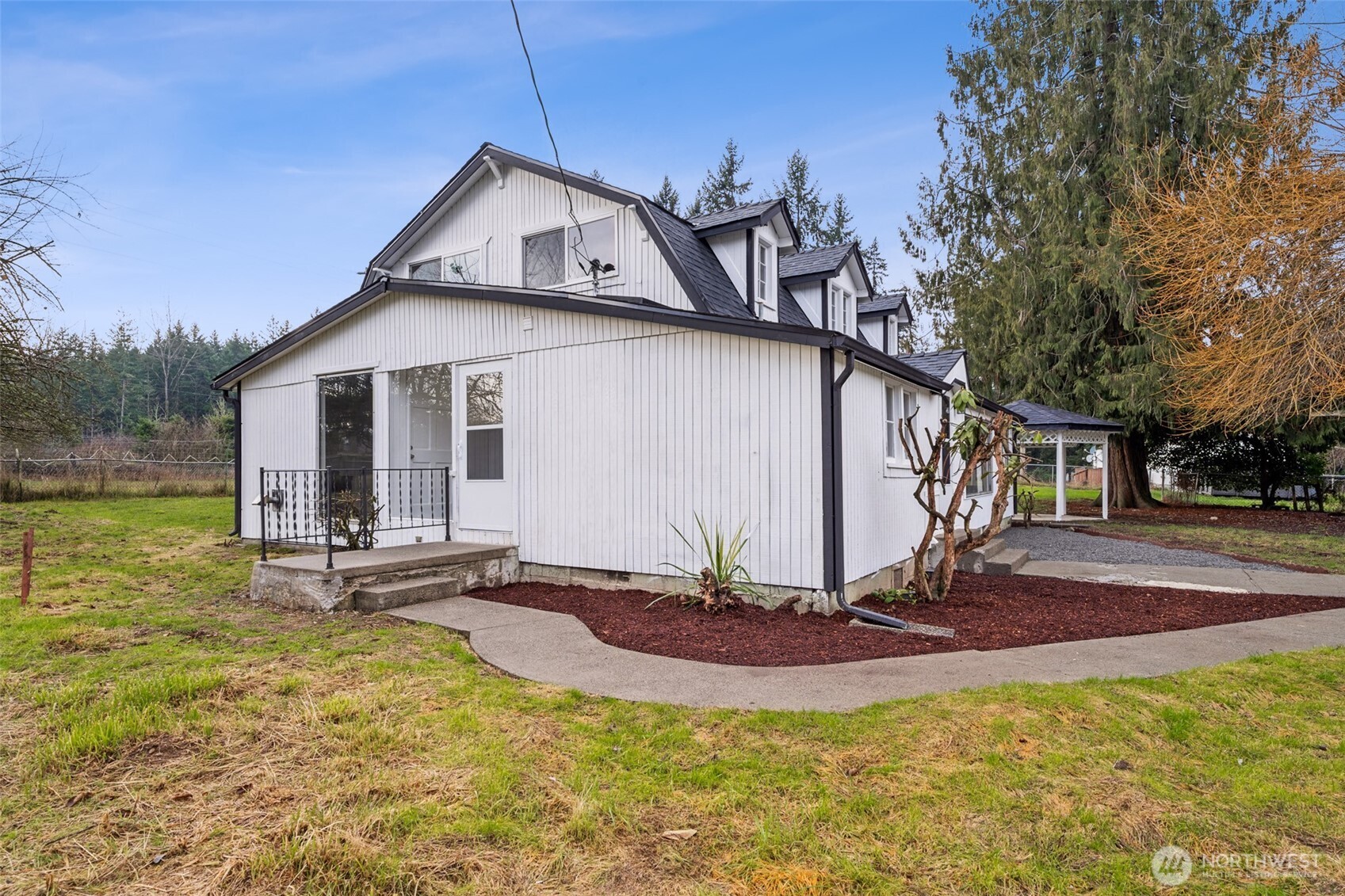 35120 Kinsman Road East Roy, WA 98580 - Photo 34 of 40 a front view of house with a garden and trees