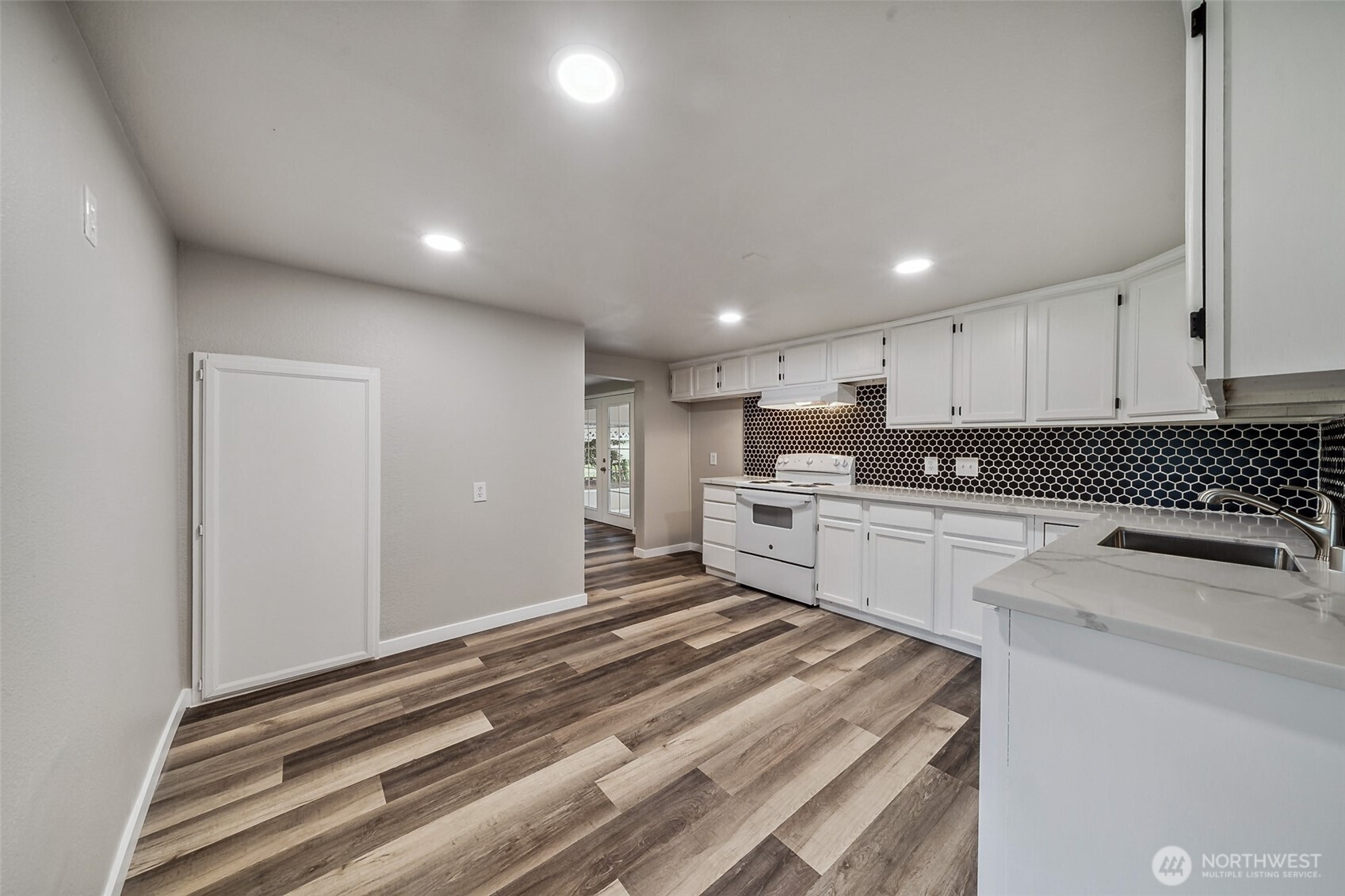 35120 Kinsman Road East Roy, WA 98580 - Photo 6 of 40 a kitchen with granite countertop white cabinets and white appliances
