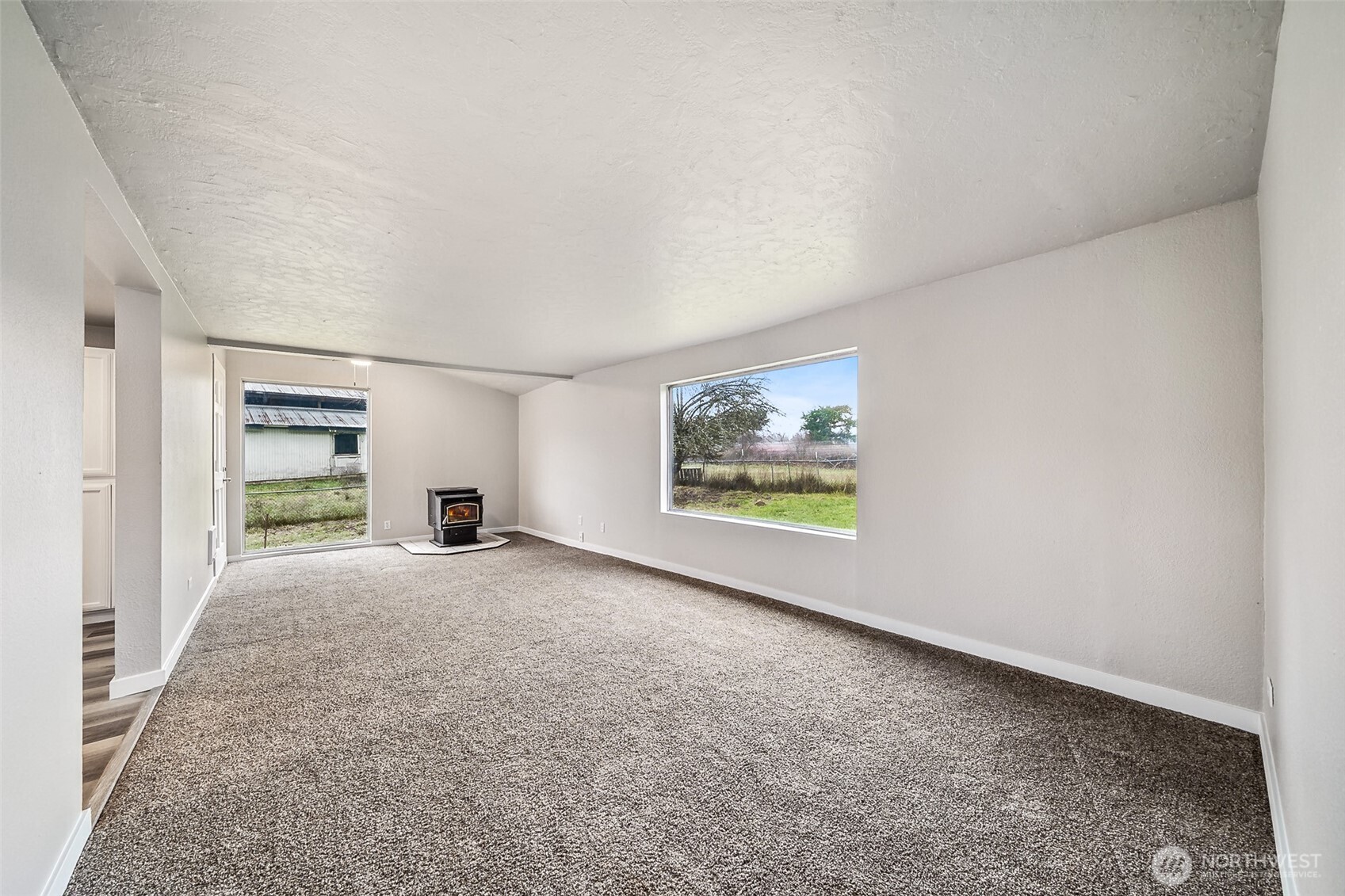 35120 Kinsman Road East Roy, WA 98580 - Photo 8 of 40 an empty room with windows and fireplace