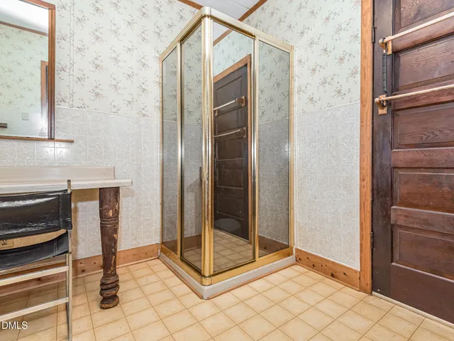 a bathroom with a shower and closet