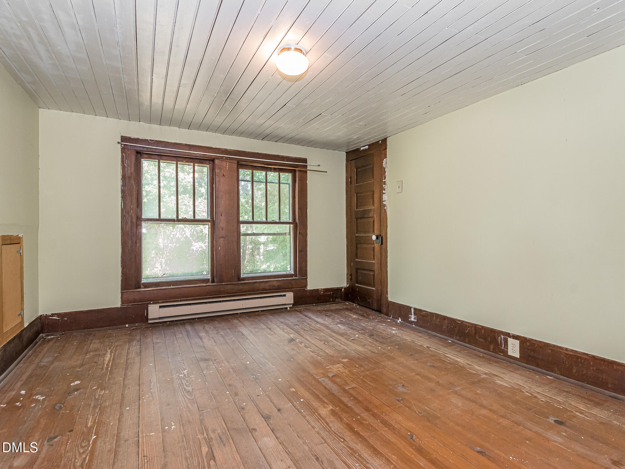 381 Royal Road Roseboro, NC 28382 - Photo 21 of 30 an empty room with wooden floor and windows
