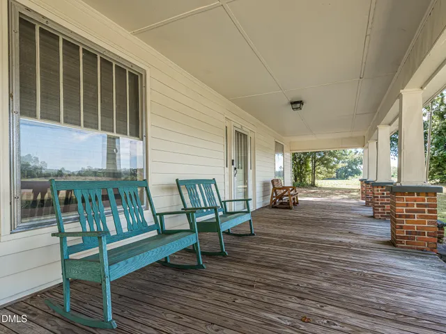 a view of a porch with wooden floor and outdoor seating